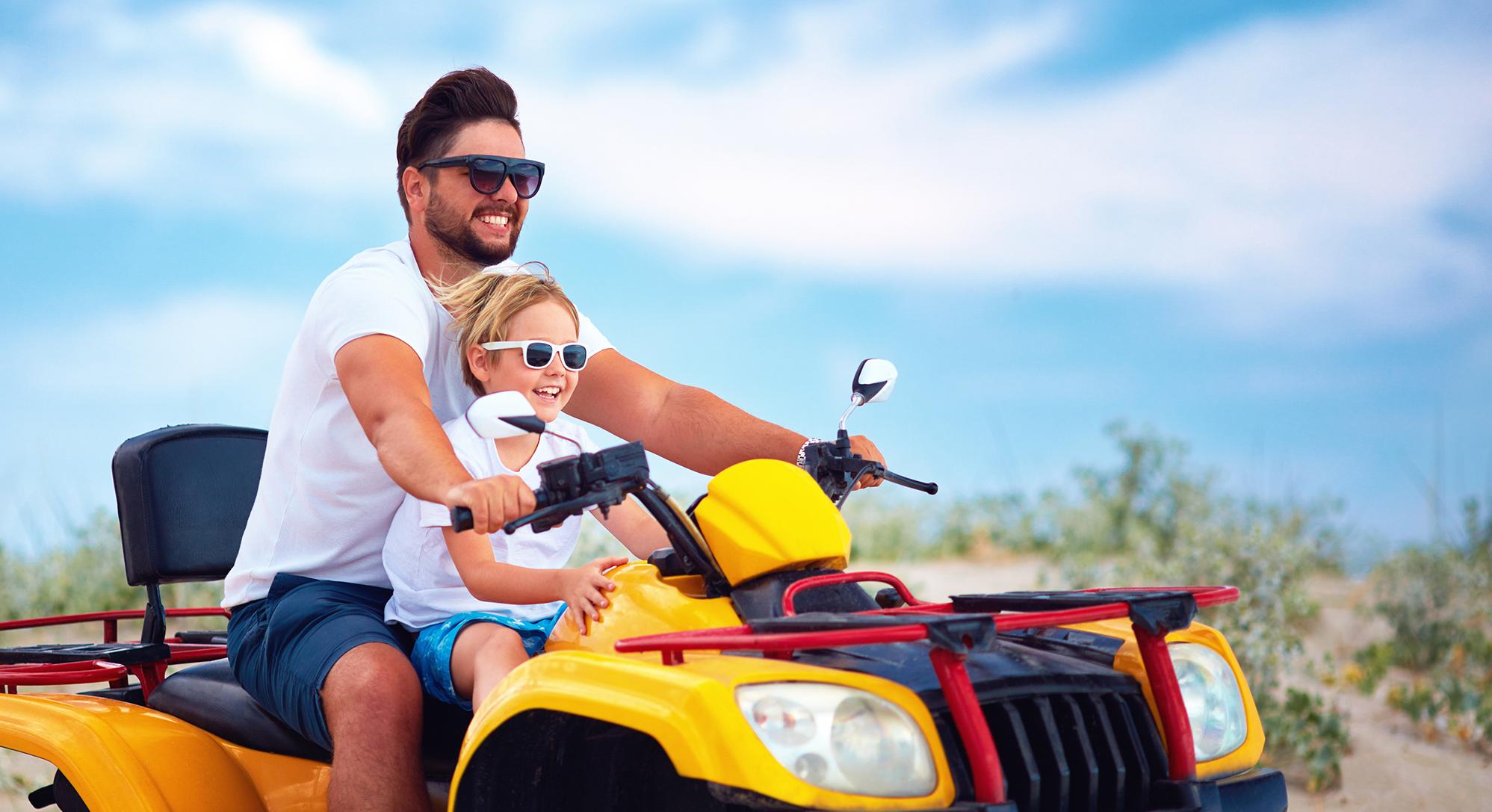 Man and child on fourwheeler